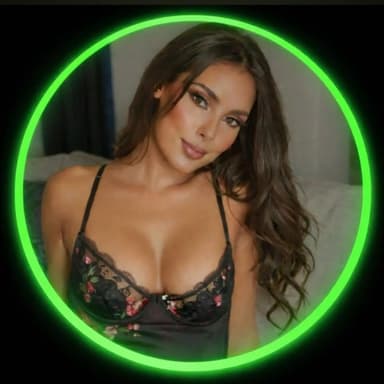 Portrait of a woman wearing black floral lace lingerie with long wavy hair, framed by a glowing green neon ring.